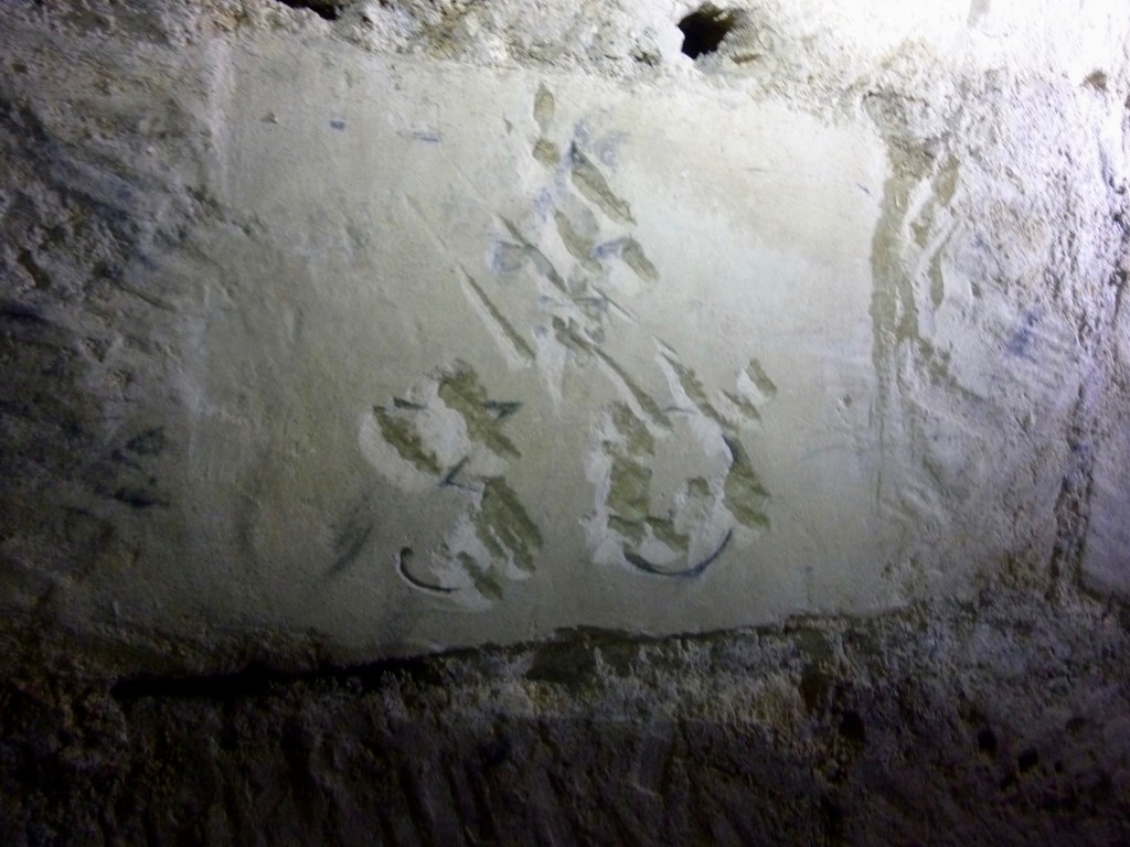 Scratched-out fleur-de-lys and number 30.